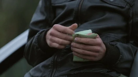 Man leafing through a wad of money Stock Footage 71604452