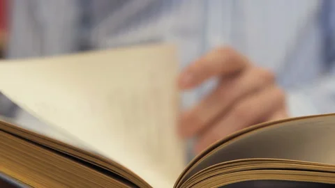 A man leafs through a book, looks for himself interesting lines Stock Footage 120162651