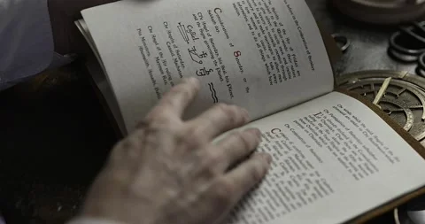 Man leafs through an early Heptameron book of magic #3 (grd) Stock Footage 226411495