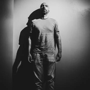 A man leaning against the wall in a dramatic environment Stock Photos