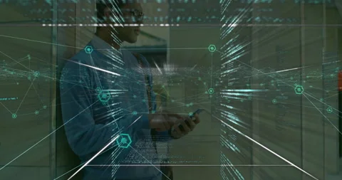 Man leaning against wall, tapping smartphone in corporate tech hallway, with 库存影片 307449611