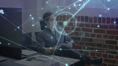 Man leaning back after checking data at tech desk, adjusting mask while network Stock Footage 329812943