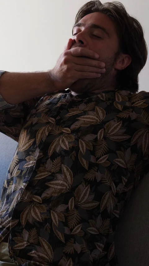 Man Leaning Back and Bored Watching TV Stock Footage 295143698