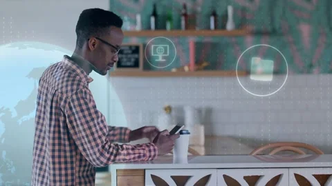 Man leaning on counter tapping smartphone, calling tech HUD icons floating, Stock Footage 333803223