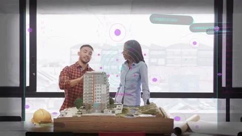 Man leaning forward pointing at building model while woman listening, conducting Stock Footage 333287498