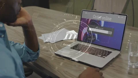 Man leaning left elbow, moving right hand to laptop while banking HUD rotating, Stock Footage 333594936