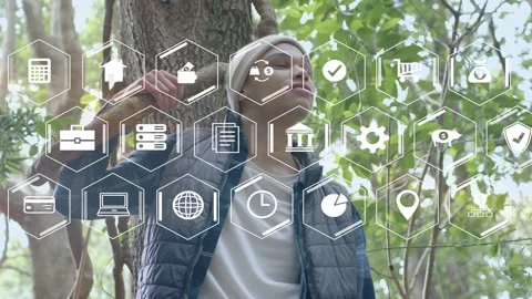 Man leaning on tree holding stick, hex icons appearing and man lifting hand, Stock Footage 333610279