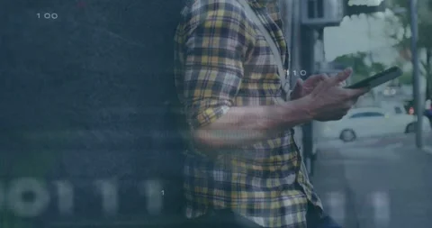 Man leaning on wall tapping tablet, biting apple, tech overlays animating over Stock Footage 334114294