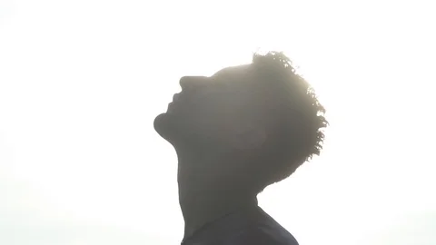Man Leans His Head Back in Sun Ray Stock Footage 106784016