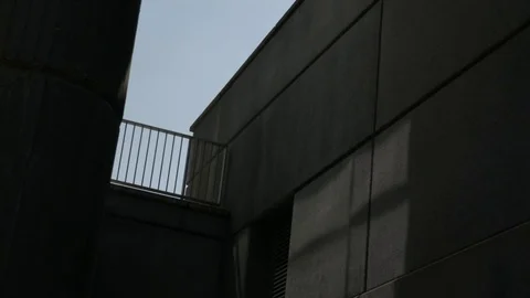 Man leans on a railing smoking Stock Footage 74128334