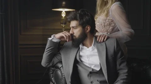 Man leans on sofa with hand at face lady hand on shoulder Stock Footage 103934864