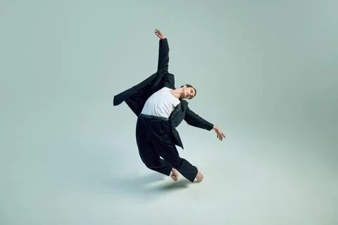 Man leaping forward with arms open symbolizing shift from strict corporate world Stock Photos