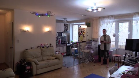 Man learn fly drone at home room with remote control. Time lapse Stock Footage 102257828