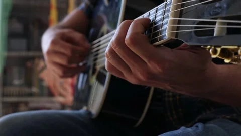 A man is learning to play the guitar. Close-up. Video stock 244878187