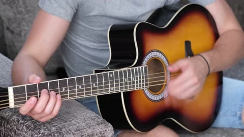 Man learning to play the guitar at home. Stock Footage 210774417