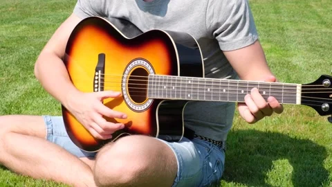 Man learning to play the guitar. Man practicing in playing guitar. Stock Footage 210774342