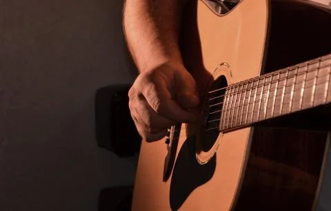 A man is learning to play the guitar. Stock Photos