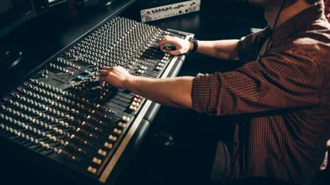 Man is learning to regulate the sound of the music Foto stock