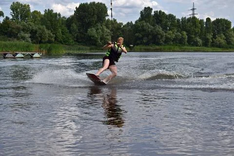 A man is learning to ride a wakeboard. Stock Photos