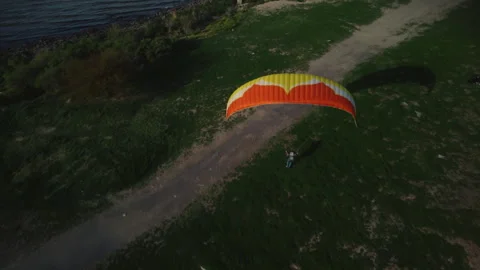 A man learns to control a paraglider from the ground, jump Stock Footage 252173988