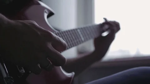 A man learns to play the guitar Video stock 82911465