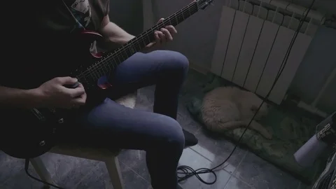 A man learns to play the guitar Video stock 82911503
