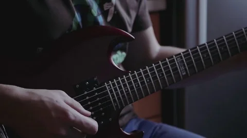 A man learns to play the guitar Stock Footage