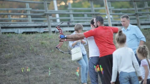 A man learns to shoot a crossbow Stock Footage 55212220