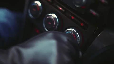 A man in leather gloves change the temperature in the car interior Stock Footage 170555190