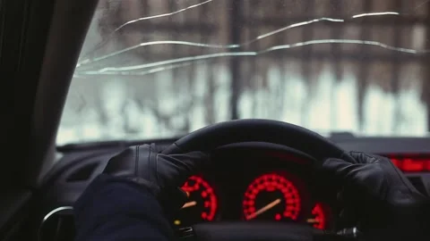 Man in leather gloves puts his hands on the wheel , broken glass Stock Footage 170555233