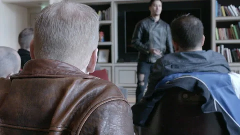 Man in Leather Jacket Giving Presentation to Audience Stock Footage 343970448