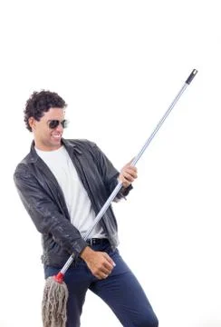 Man in leather jacket playing on a broom Stock Photos