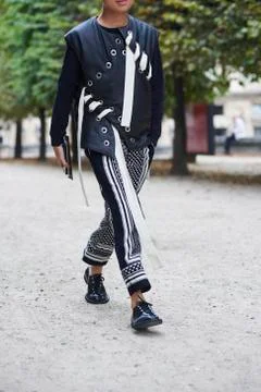 Man in leather jerkin and patterned trousers walking, crop 스톡 사진