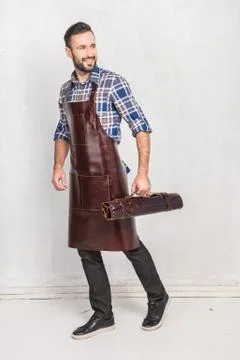 A man in a leather kitchen apron Stock Photos