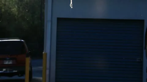 Man Leaves and comes back in a storage garage Stock Footage 20548630