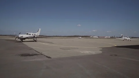 The man leaves the private plane and goes to the car Stock Footage 94234875