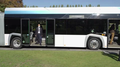 Man leaving electrical bus Stock Footage 220010043