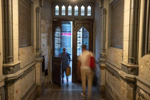 Man leaving an old building while other man coming in Stock Photos