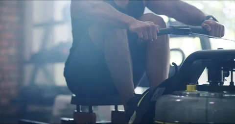 Man, leg and rowing machine in gym with workout, exercise or training for Stock Footage 253431723