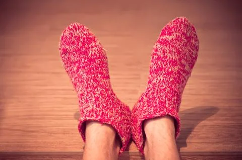 Man legs in red wool socks male knitted clothes winter handmade accessories h Stock Photos