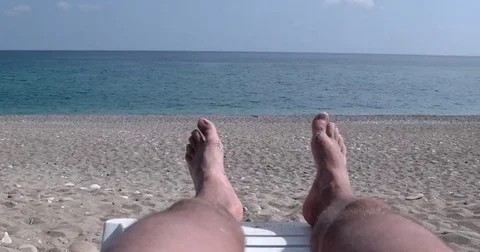 Man Legs on Sunbed, View on the Beach and Sea Stock Footage 69181986