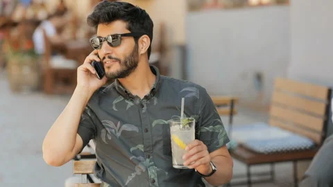Man with Lemonade Talks on Phone Stockbeeldmateriaal 91792446