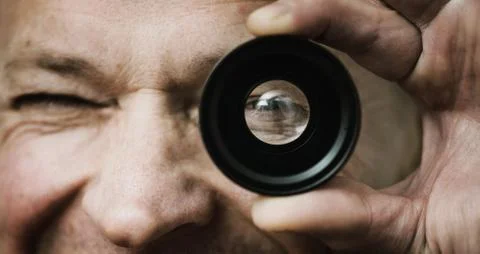 The man with a lens. Stock Photos