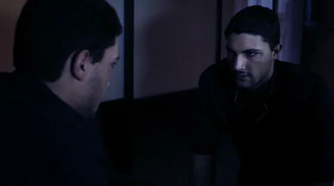 Man let off some steam with himself in the mirror Stock Footage 34272139