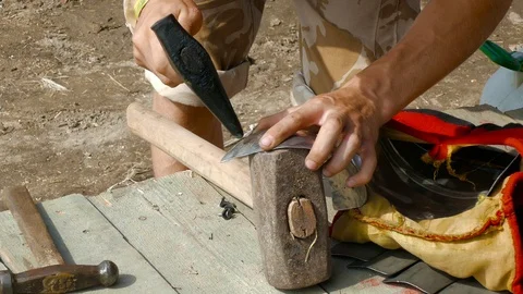 Man leveled part of the plate armor from dents Stock Footage 123583618