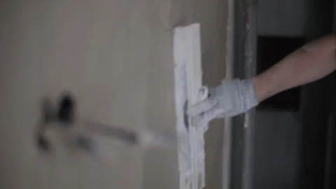 Man leveling the wall with a spatula Stock Footage 295277582