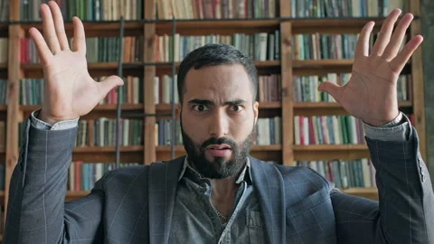 Man In The Library Shows Hand Gesture As If He Had An Explosion In His Head. Stock Footage 140222525