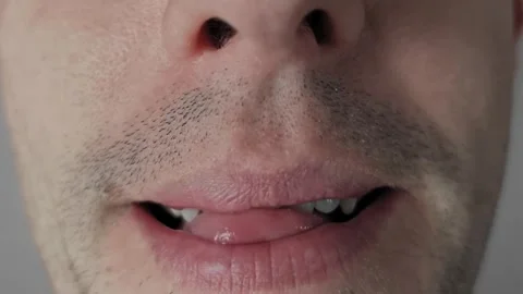 Man Licking Lips and Teeth Macro View Stock Footage 318165265