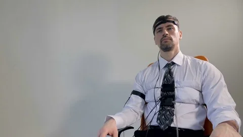 A man with lie detector sensors in close-up. Stock Footage 78294366