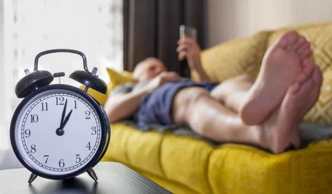 A man lies on the couch during lunch. Stock Photos